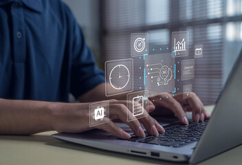 Man using laptop with artificial intelligence and digital data icons. Concept of AI technology, automation, innovation, and smart solutions for modern business productivity and data management.