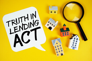 TIL Truth in Lending text with house models and magnifying glass on yellow background