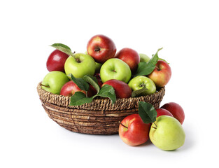 Fresh ripe apples with green leaves in wicker basket isolated on white