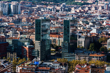 Bilbao cityscape featuring modern architecture and traditional buildings under sunlight.