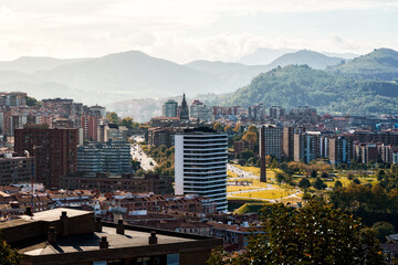 Bilbao cityscape featuring modern architecture and traditional buildings under sunlight.