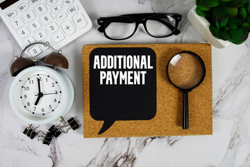 Additional Payment text with Calculator, alarm clock and magnifying glass on marble background