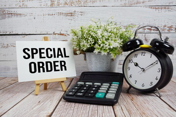 Special Order text with alarm clock and calculator on wooden background