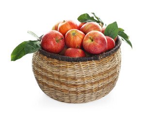 Fresh apples in wicker basket and green leaves isolated on white
