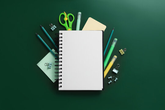 Happy teacher's day. Blank notebook and stationery on green background, flat lay