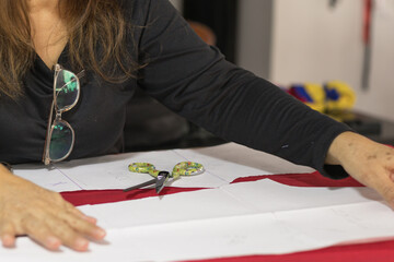 Woman working on fabric pattern in sewing workshop