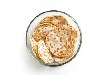 Top view of Keripik Tempe or Tempeh Chips in glass bowl. Isolated on white background with copy space. Traditional Indonesian food are made from soybeans mixed with rice flour then sliced ​​thinly.