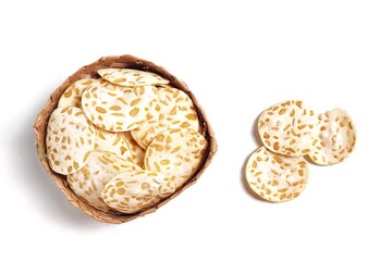 Top view of Keripik Tempe or Tempeh Chips in bamboo basket. Isolated on white background with copy space. Traditional Indonesian food are made from soybeans mixed with rice flour then sliced ​​thinly.