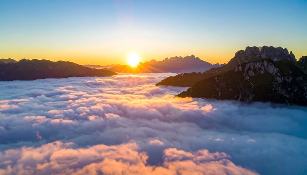 Sunrise over a sea of clouds, mountain peaks piercing through