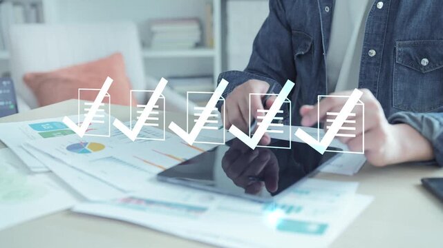 Business professional using digital technology for document management and approval, completing a project checklist on a tablet.