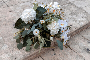 Luxury wedding bouquet placed on stone steps