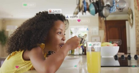 Girl scooping cereal at counter sparking social media notifications floating around spoon and bowl - Powered by Adobe