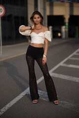 Woman posing on the road wearing fashionable clothes