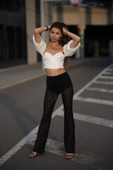 Woman posing on the road wearing fashionable clothes