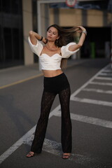 Woman posing on the road wearing fashionable clothes