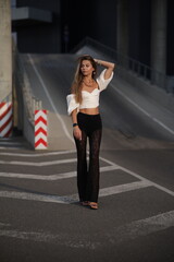 Woman posing on the road wearing fashionable clothes