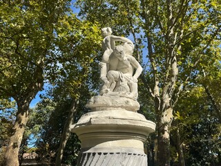 Obraz premium Parma, Italy, October 7, 2025 Beautiful classical marble statue under blue sky in green park, Parma, Italy. Author: Djundiet A.