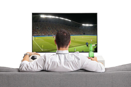 Man watching a football game on tv and holding a bottle of beer