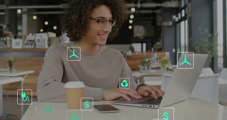 Man typing on laptop seeing smartphone plug icon fading spawning energy finance icons for insight - Powered by Adobe