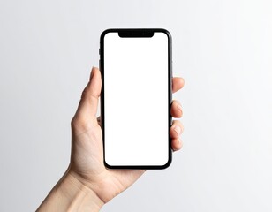 Hand holding a smartphone with a blank white screen, against a white backdrop