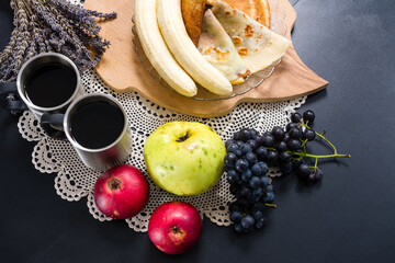 Breakfast spread with pancakes, fruit, and coffee