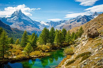 Beautiful clear green mountain lake with the reflection of the Matterhorn mountain in the water
