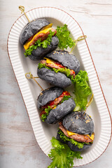 set black mini hamburgers, mini burgers on a white background top view