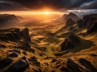 Golden sunset bathes a mountain valley, dramatic sky, and winding road
