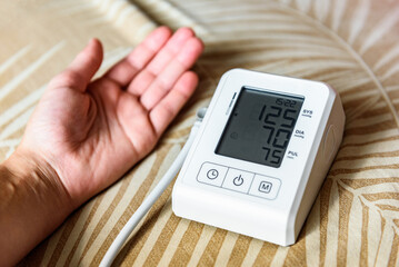 Measuring blood pressure with an automatic blood pressure monitor at home.