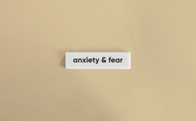 Anxiety and Fear Text on White Letter Tile over Beige Background