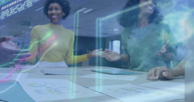 Coworkers after chart review extending and stacking hands with animated graphs for business unity
