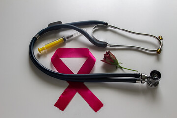 Emblem for World AIDS Day, stethoscope, syringe, rose. On a white background.