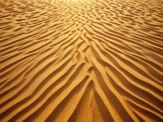 Golden sand dunes texture under sunlight with wavy patterns, desert landscape