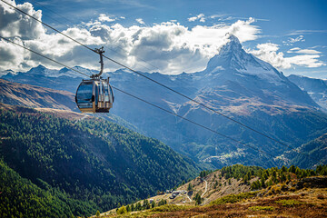 Gondola lifts in the Alps, against the backdrop of a mountain landscape