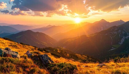 Golden sunset bathes mountain ranges, illuminating valleys with warm light and colors
