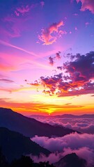 Dramatic sunset over majestic mountains, with vibrant colors reflecting