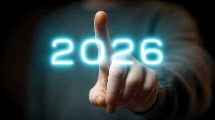 Person Pointing a Finger at a Glowing Blue Digital 2026 Number for the New Year