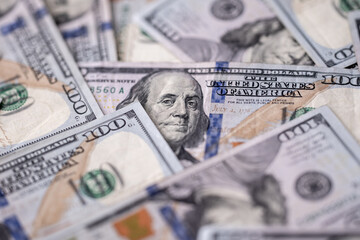 Money background with 100-dollar bills. Texture of US money currency. 100 USD banknotes in focus. American hundred-dollar money backdrop. Pattern of US dollars. Money for finance concept.