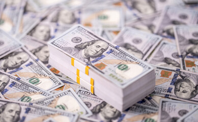 Stack of dollars and cash with a money background. US dollars currency and banknotes. Pile of 100 USD bills. American hundred-dollar notes. Pattern of dollars. Cash and credit theme. Deposit dollars.
