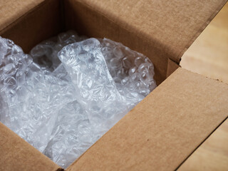 An open cardboard box with bubble wrap inside. Close up.