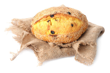 Loaf of fresh bread with sesame seeds, raisins and burlap cloth isolated on white