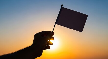 A hand holds a small flag against a vibrant sunset, hope new beginnings.