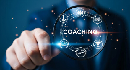 Hand holding magnifying glass focusing on "Coaching" surrounded by icons representing teamwork, strategy, communication, and success, symbolizing business development and personal growth