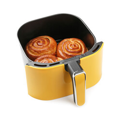 Air fryer basket with baked buns isolated on white