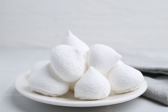 Delicious meringue cookies on white table, closeup