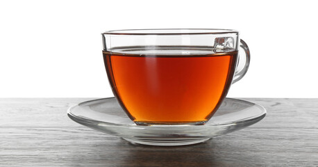 Cup of aromatic black tea on dark wooden table against white background
