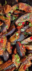 Fried Eggplant With Spicy Hot Peppers, Garlic, and Fresh Herbs Served in a Colorful Dish
