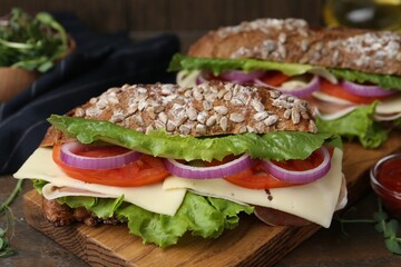 Tasty ciabatta sandwiches with cheese and vegetables on wooden table, closeup