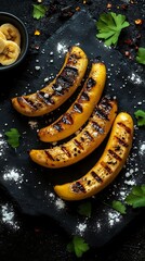 Top View Grilled Bananas with Salt on Stone Plate with parsley on black background