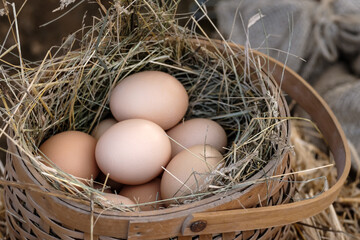 A basket full of eggs with straws in it
